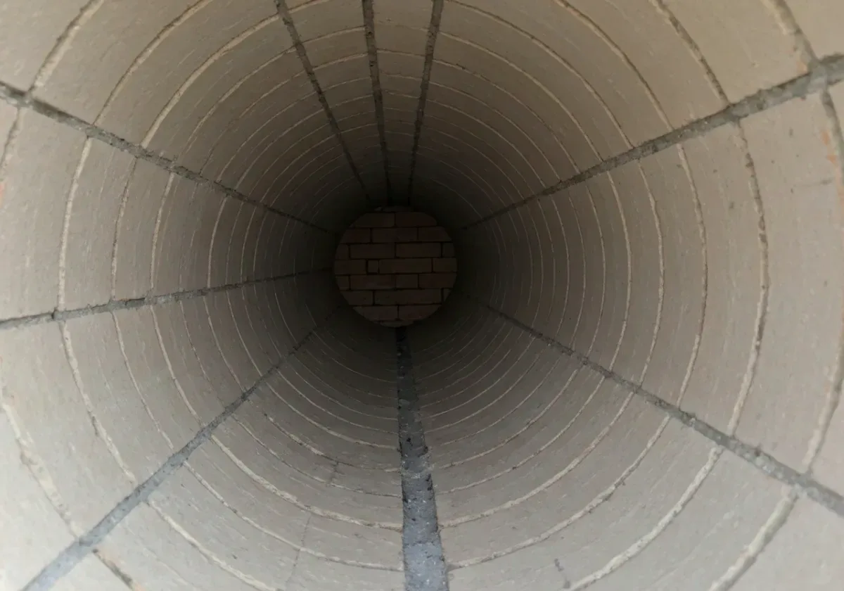 After — creosote removal: Glazed Stage 3 creosote ground off the flue walls — the fuel for a chimney fire, gone.